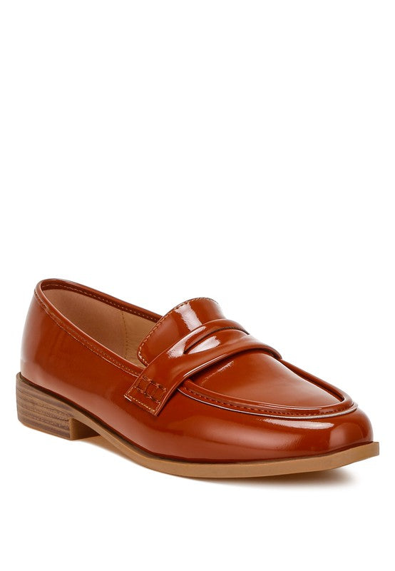 Front angle of Brown Avery Patent Loafers with penny strap detail and glossy vegan leather finish.