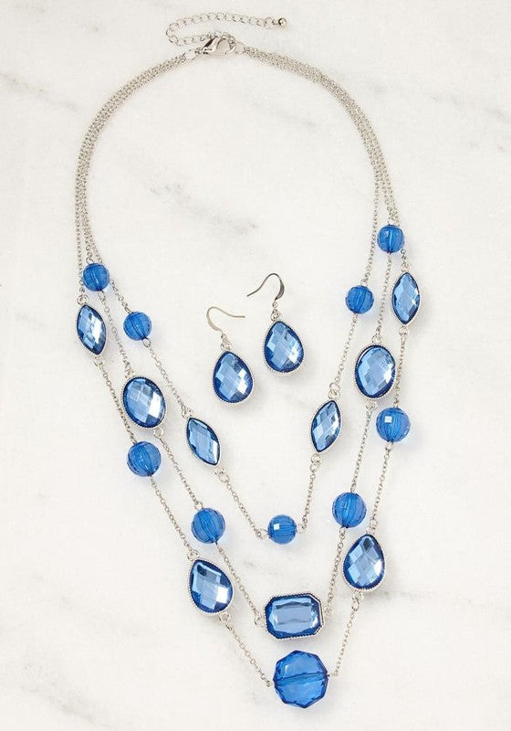 Blue Gem Layered Necklace and Earrings Set in silver tone with triple-tier design and sparkling sapphire-like gems.