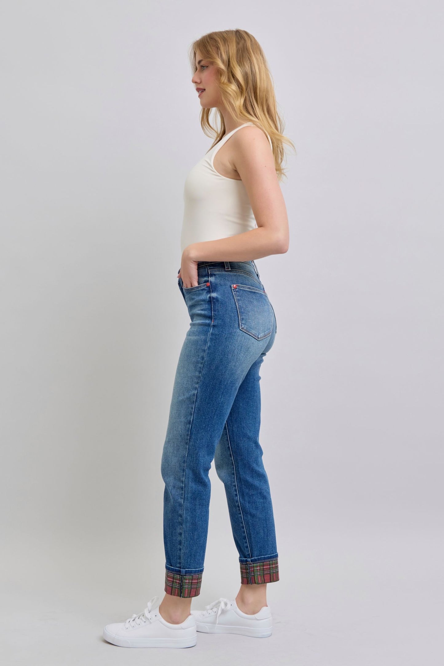 Side view of Logan Plaid Cuff Straight Leg Jeans showing straight leg silhouette, medium wash denim, and plaid hem cuffs.
