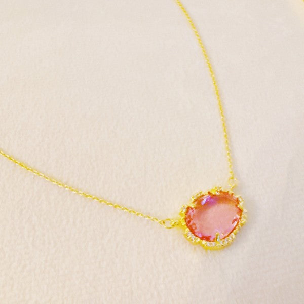 Clustered Glass Jewel Necklace with pink glass stone and gold chain, delicate flat lay.
