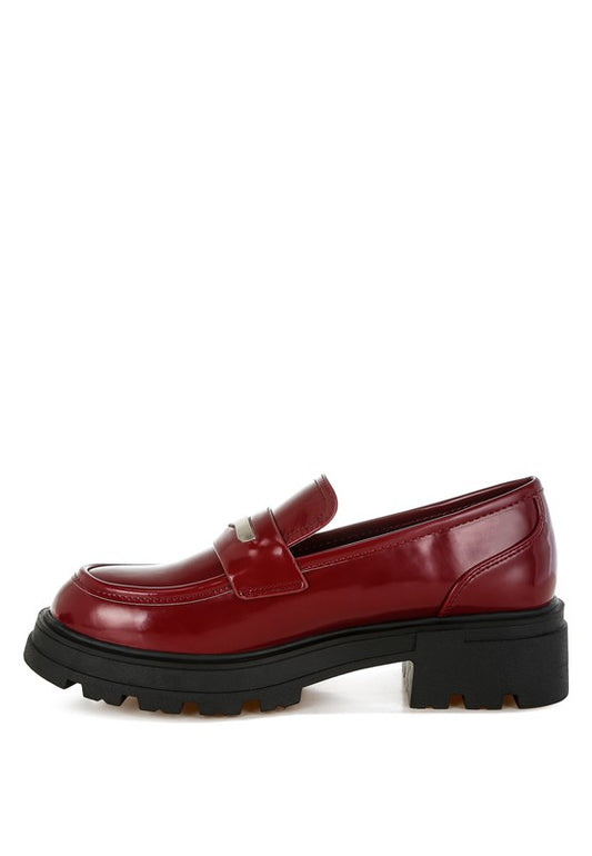 Medial view of Burgundy Gleam Stride Chunky Loafers highlighting faux leather upper and block heel.
