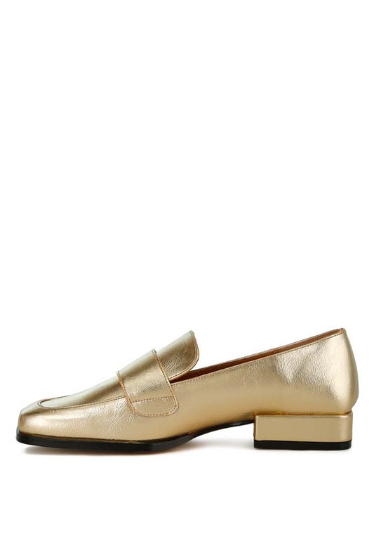 Side angle view of gold Jovana metallic penny loafers showing low block heel.