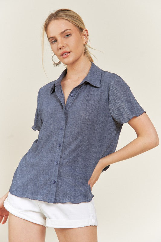 Model wearing denim blue Tilda textured button down shirt front.
