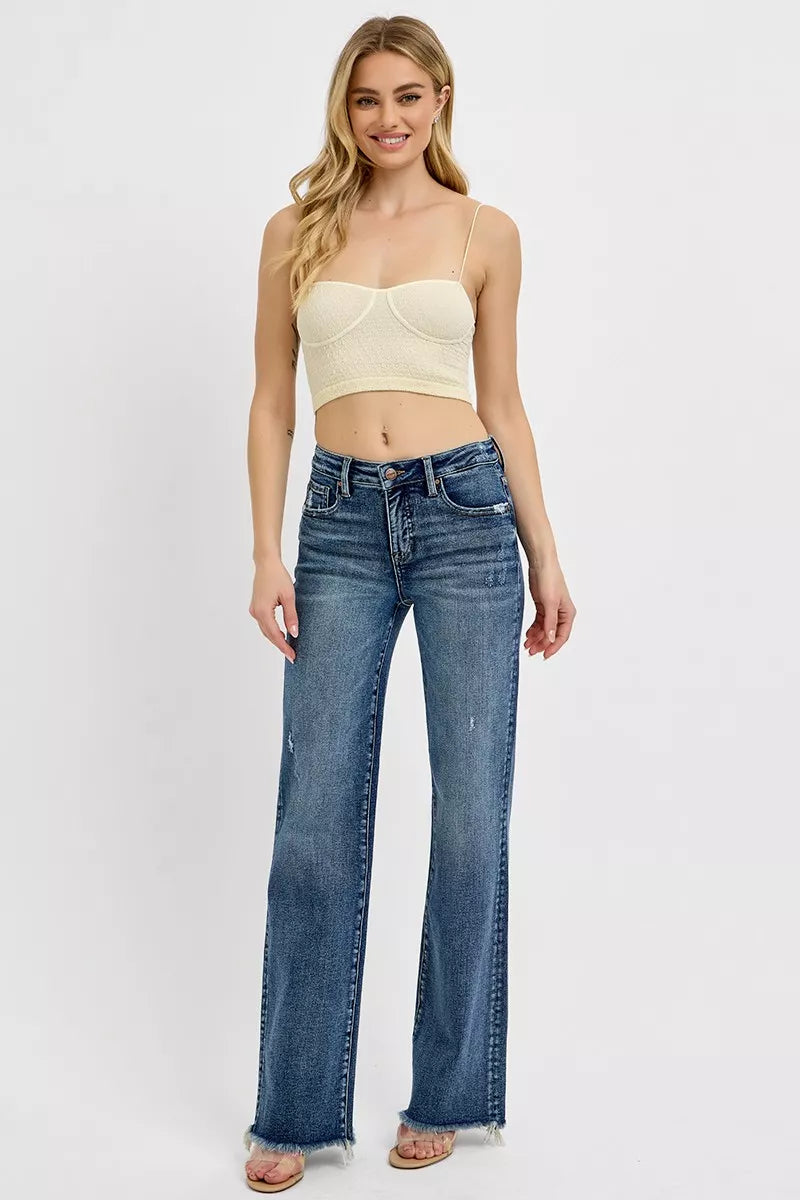 Model in Vivica Tummy Control Jeans, long straight leg fit in dark wash with raw hem and subtle distressing