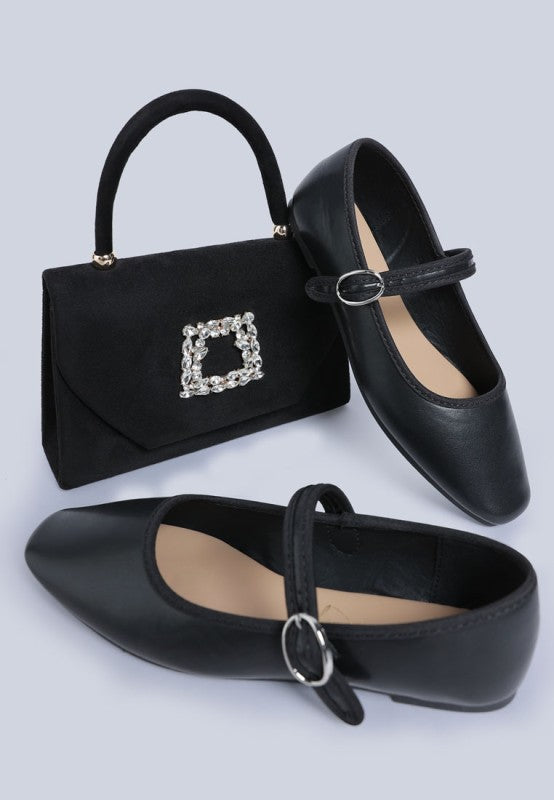 Black faux leather Iker ballerinas, flat heel and ankle strap front angle.
