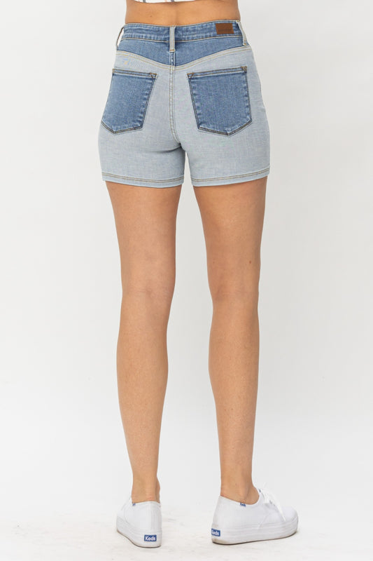 Back view of Zara Color Block Denim Shorts by Judy Blue showing dark wash waistband and pockets.