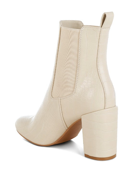 Inside angle view of beige Briony Patent Block Heel Ankle Boots showing elasticated gusset.