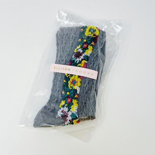 Packaged gray Noble Floral Beauty Socks in clear cello bag with Ellison + Young logo sticker.