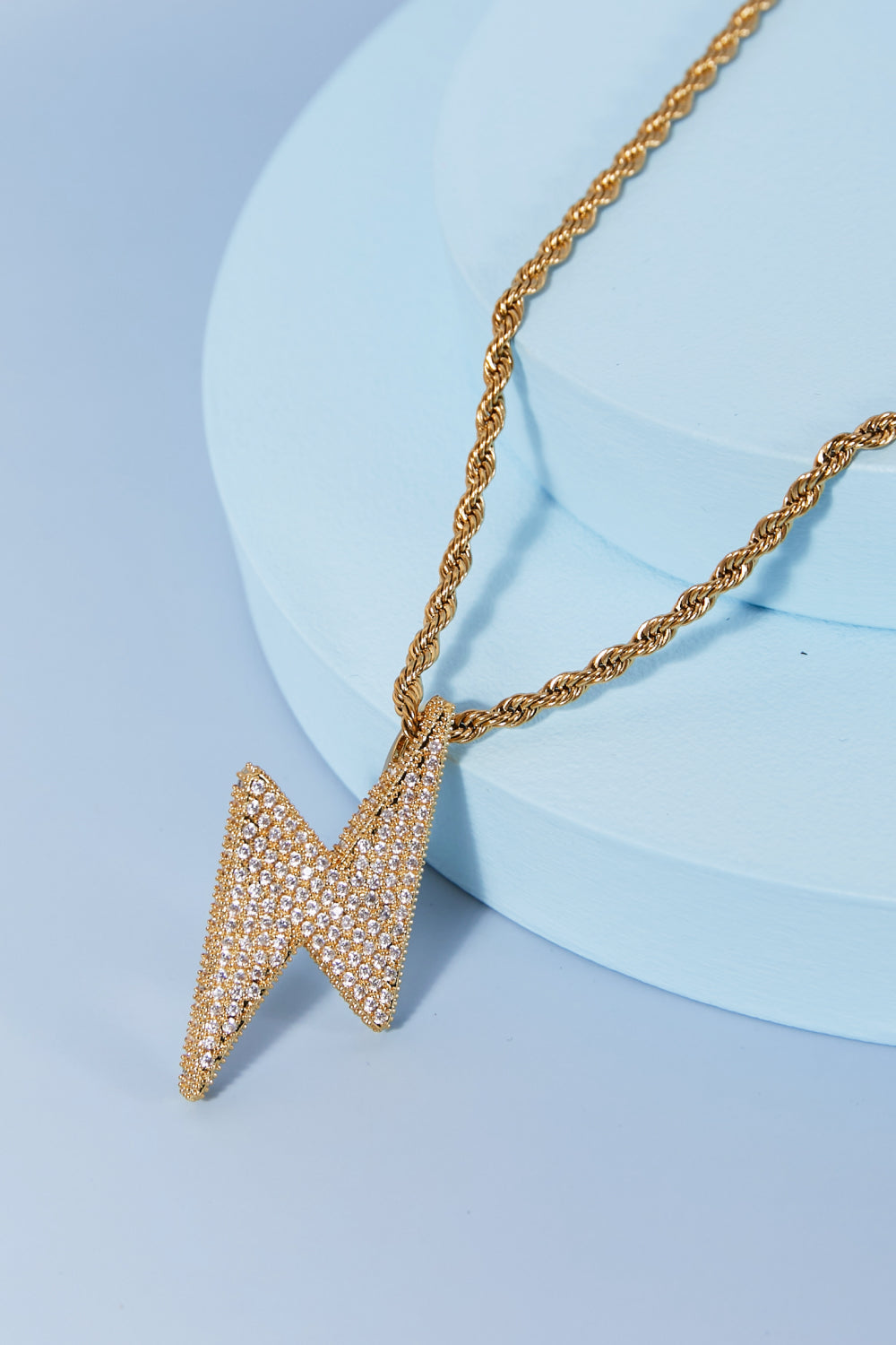 Lightning pendant necklace with a twisted chain, crafted from brass, stainless steel, and cubic zirconia for a sparkling touch.