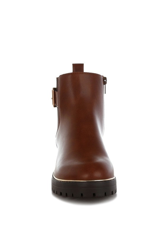 Front view of tan Antorin chunky buckle ankle boots with lug sole and platform design.