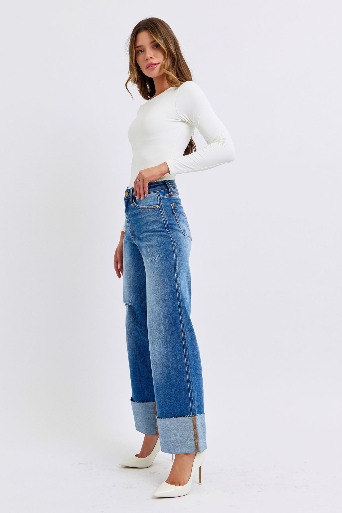 Full body side profile of Nare Plus Size Distressed Wide Leg Jeans styled chic with heels.