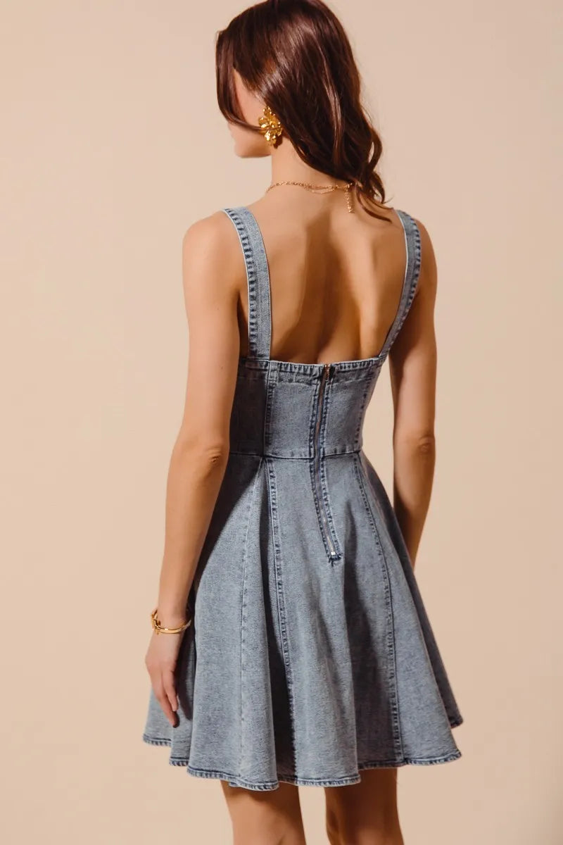 Back view of the Cassidy Denim Mini Dress showing the fitted back and flared skirt silhouette.