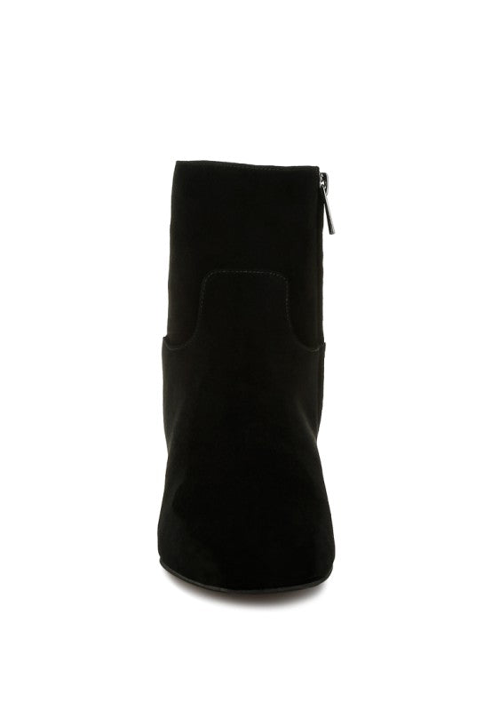 Front view of the black Hakra suede bootie highlighting the closed almond toe and minimalist silhouette.