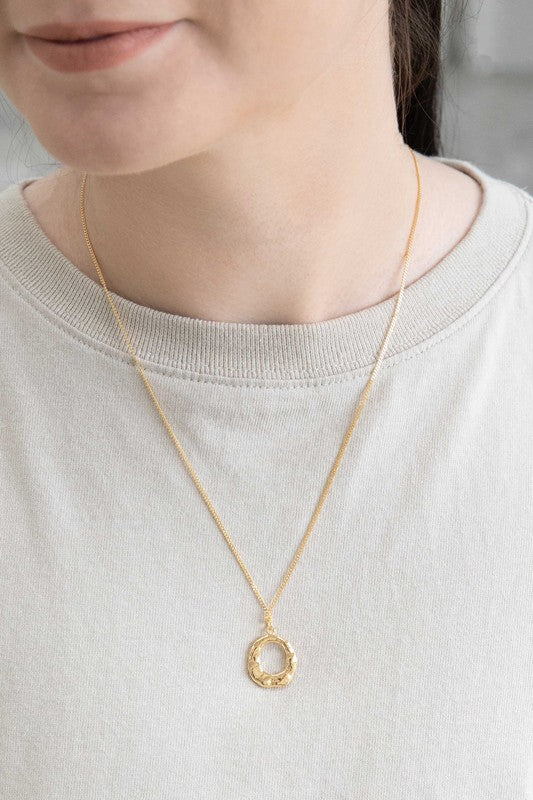 Woman wearing Charming Circle Necklace in Gold close up view