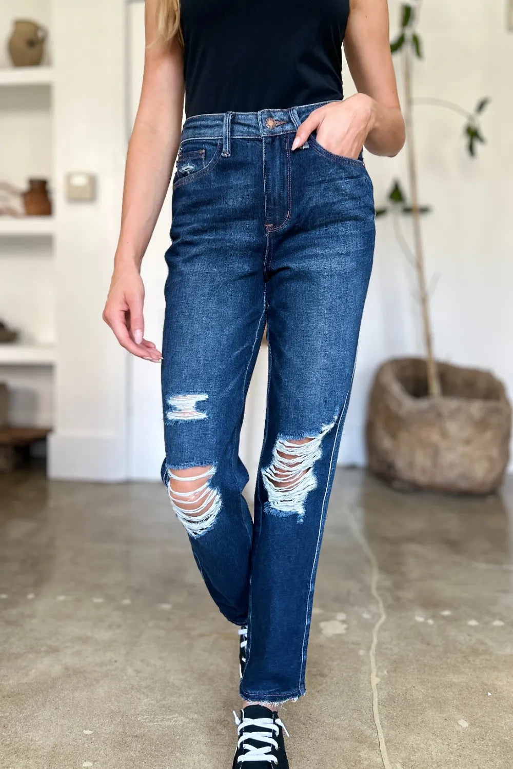 Model wearing Wynna High Waist Straight Jeans, heavy distressing and raw hem