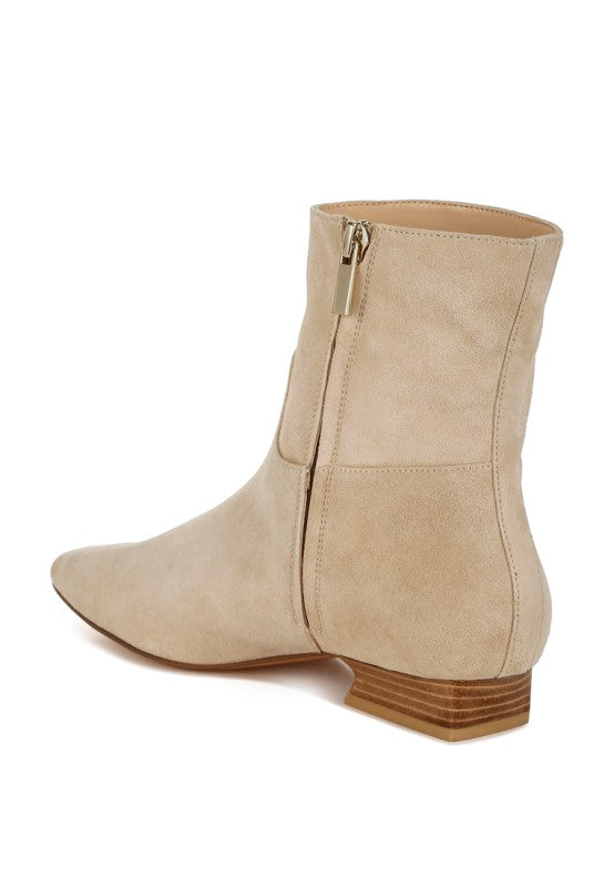 Inside view of beige Hakra suede ankle boots highlighting the zip-up closure and soft suede texture.