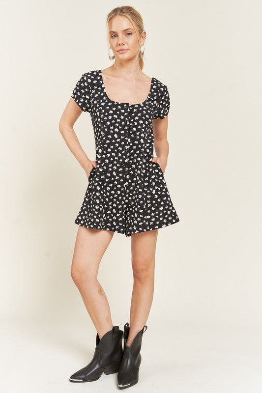 Plus Size Xiomara Floral Button-Down Romper in dark navy with short sleeves, scoop neckline, smocked back, and side pockets.