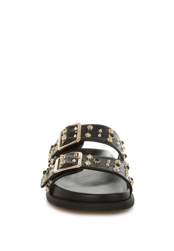Stylish black slip-on sandals with silver studs and double buckle straps, perfect for casual or evening wear.