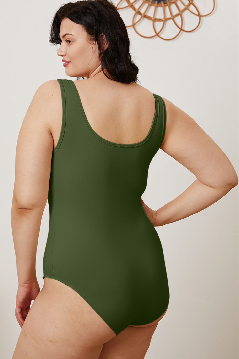 Plus size side angle of Sarah Hunter Green Bodysuit highlighting body-hugging fit.
