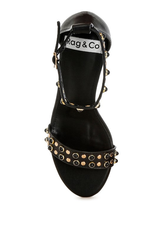 Top view of black studded leather wedge sandals with cushion insole.
