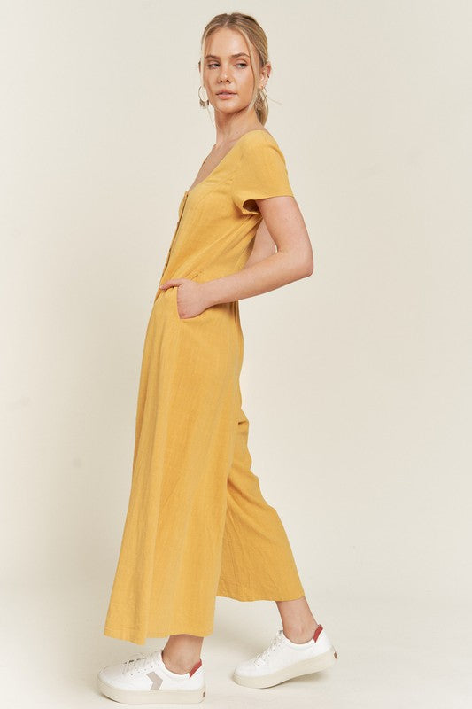 Mustard Seona Linen Plus Size Jumpsuit side view showing relaxed sleeves and side pockets.