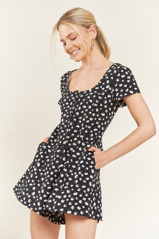 Side view of Xiomara Plus Size Floral Romper in dark navy with short sleeves, scoop neckline, and side pockets.