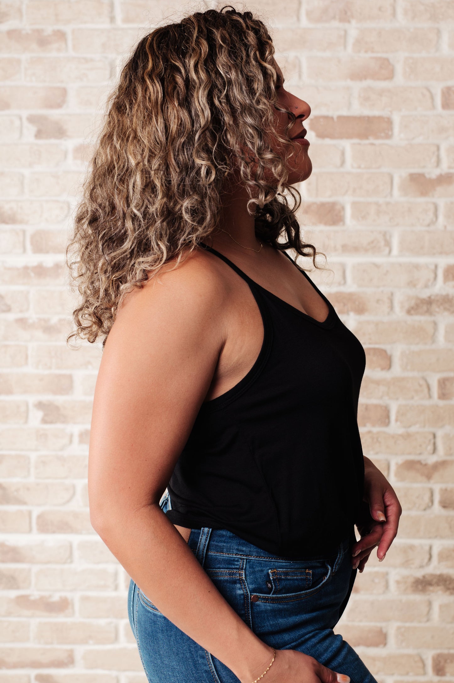 Side view of black plus size Aria tank top β stylish and comfy scoop neck design for everyday wear.