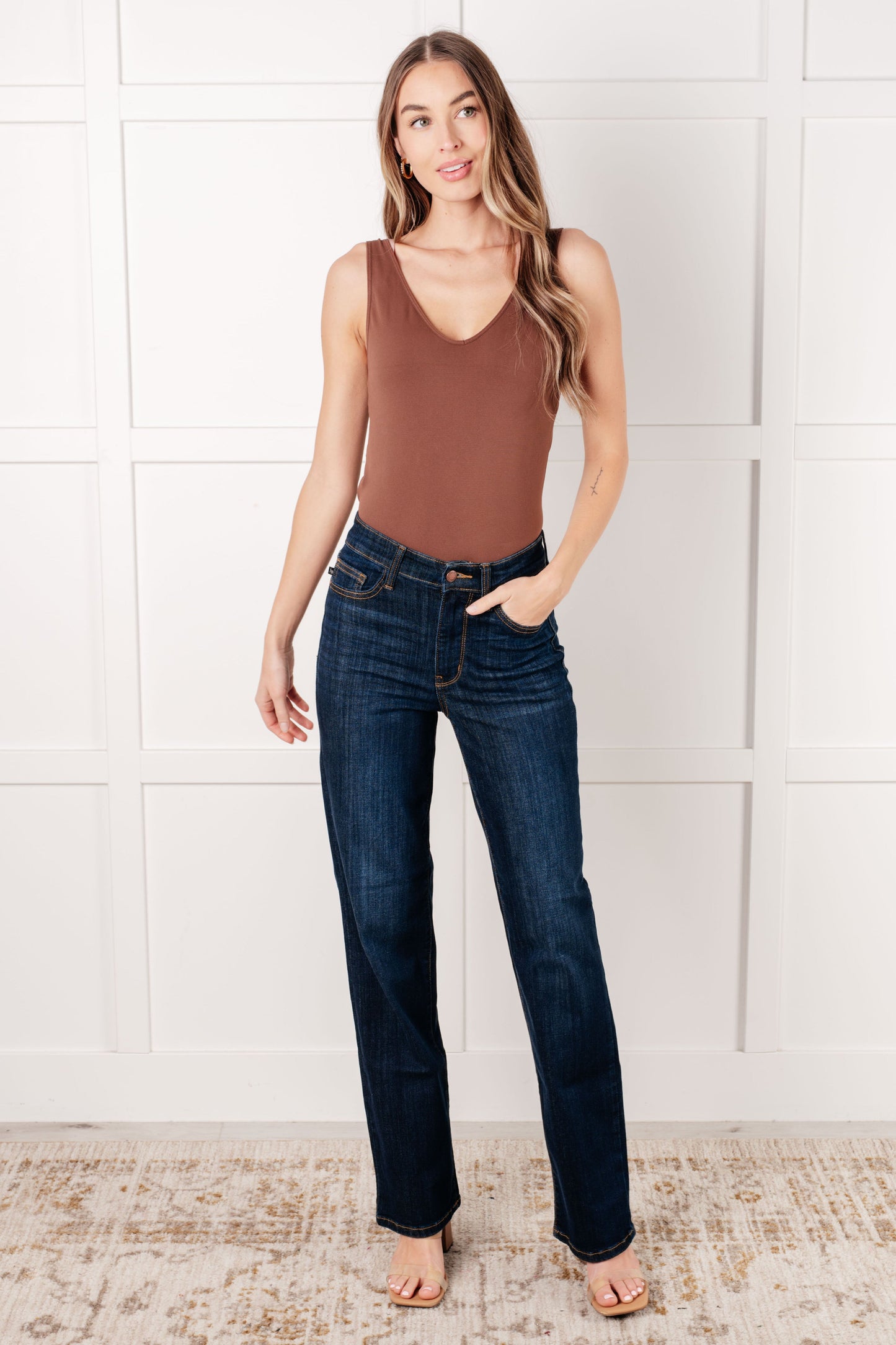 Model wearing the Judy Blue dark wash high-rise straight-leg jeans with a zip fly, 4-way stretch, and a non-distressed design.