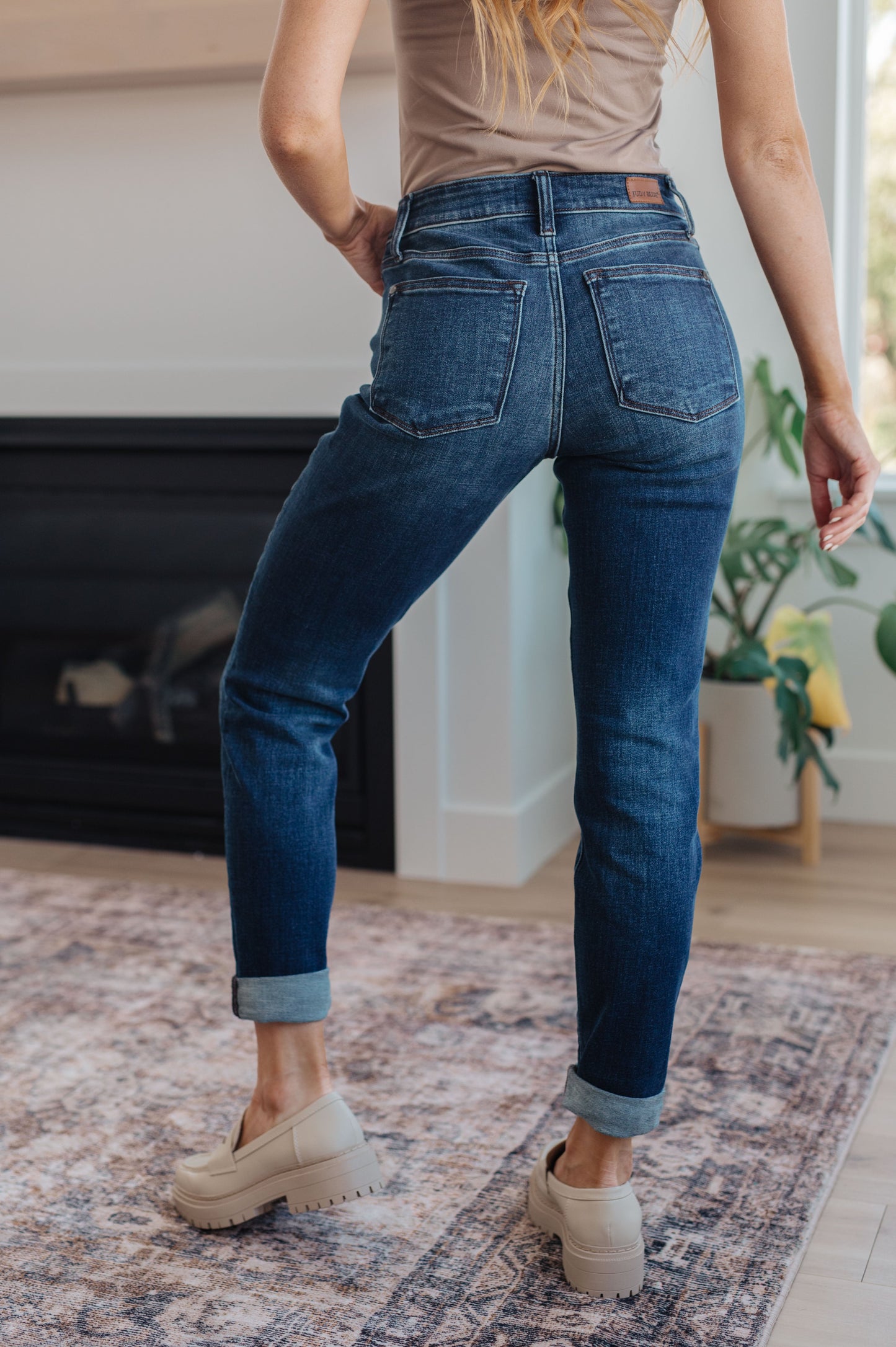 Back view of the Judy Blue Amber cuffed jeans styled with boots – mid-rise, 4-way stretch comfort.