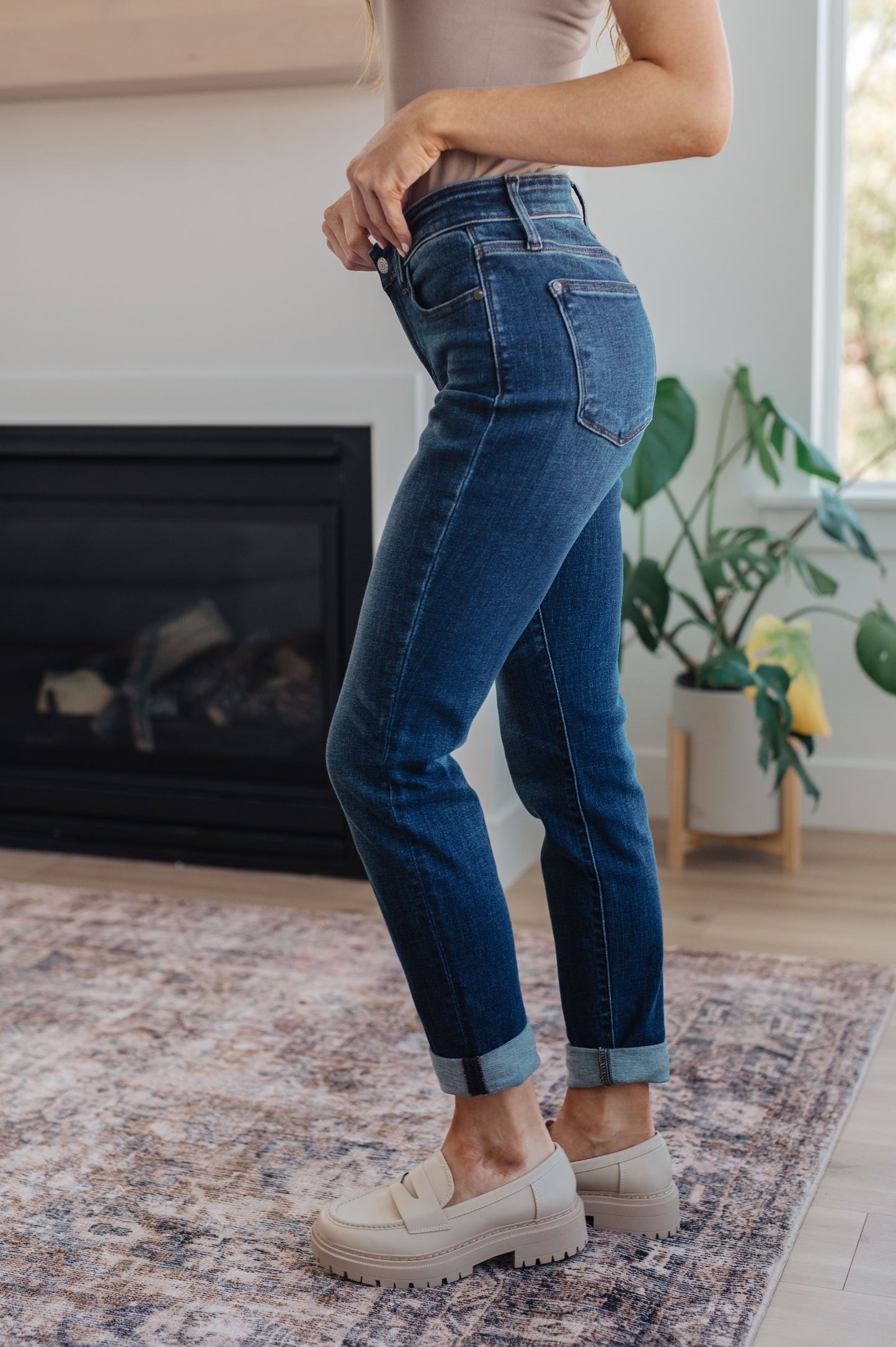 Side view of the Judy Blue dark wash slim fit cuffed jeans – flattering mid-rise stretchy denim.