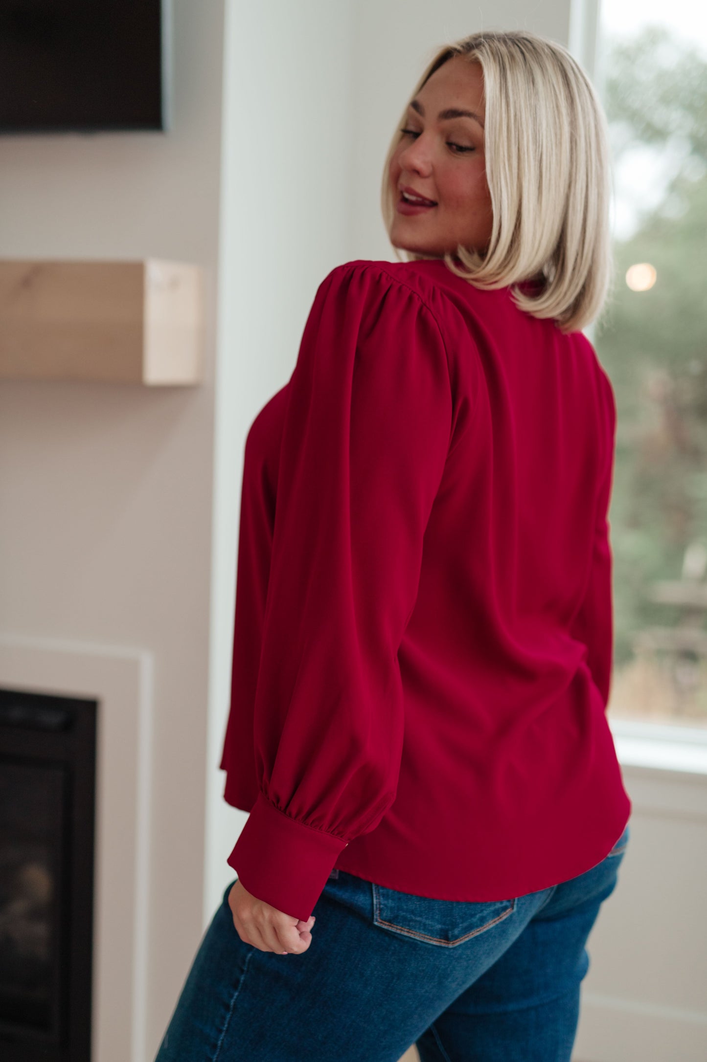 Back view of plus size Birdie V-Neck Blouse in deep wine, button cuff detail.