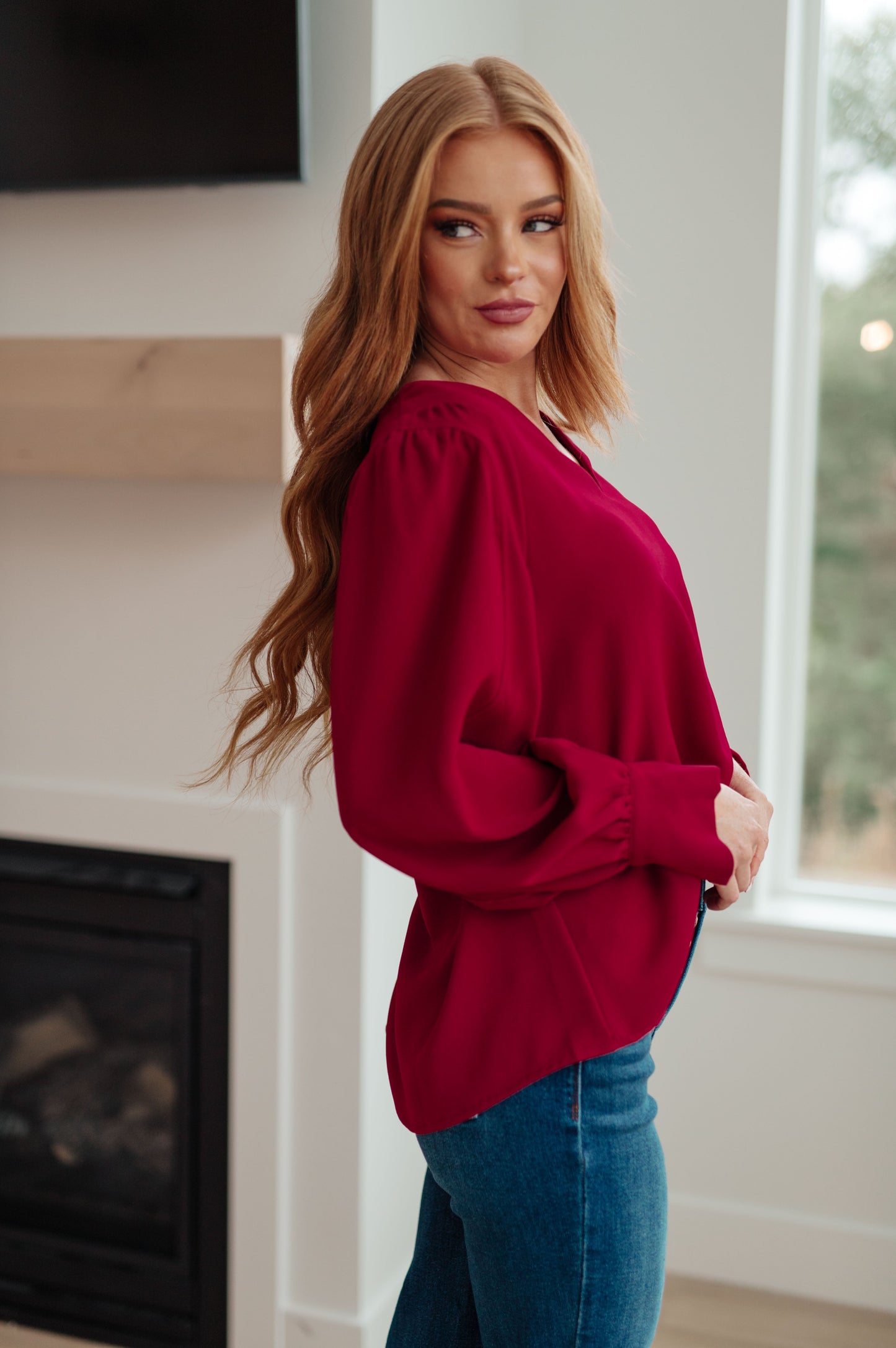 Side view of Birdie V-Neck Blouse in rich wine, puff sleeve detail.