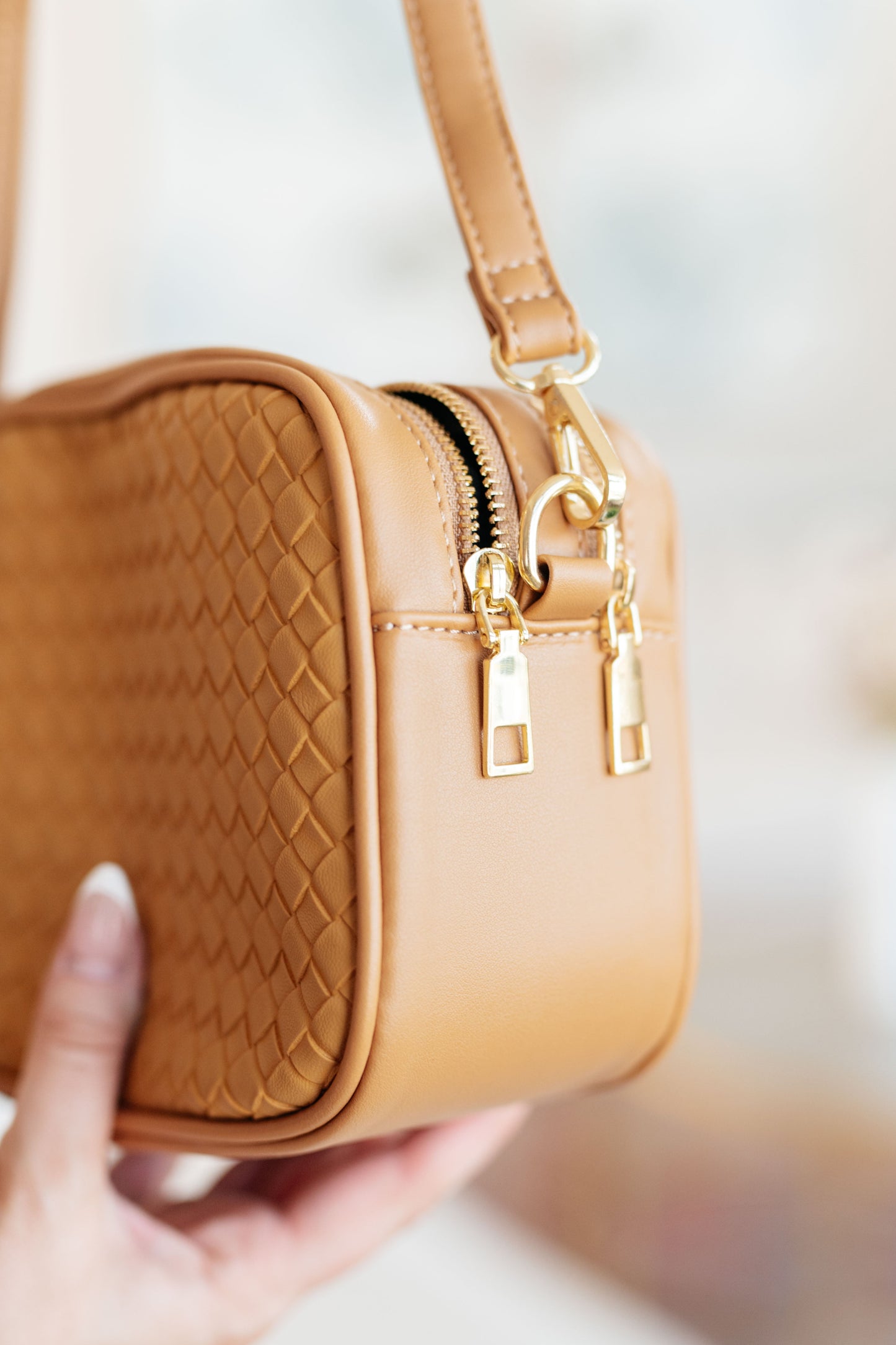 Side detail of Golden Hour Crossbody showing woven vegan leather texture and structured shape.