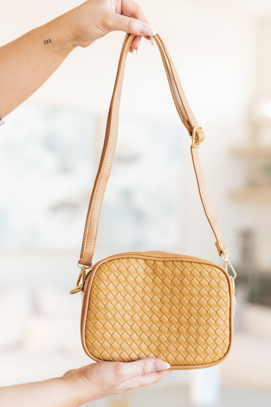 Front view of Golden Hour Crossbody with woven vegan leather, gold accents, and zippered closure.