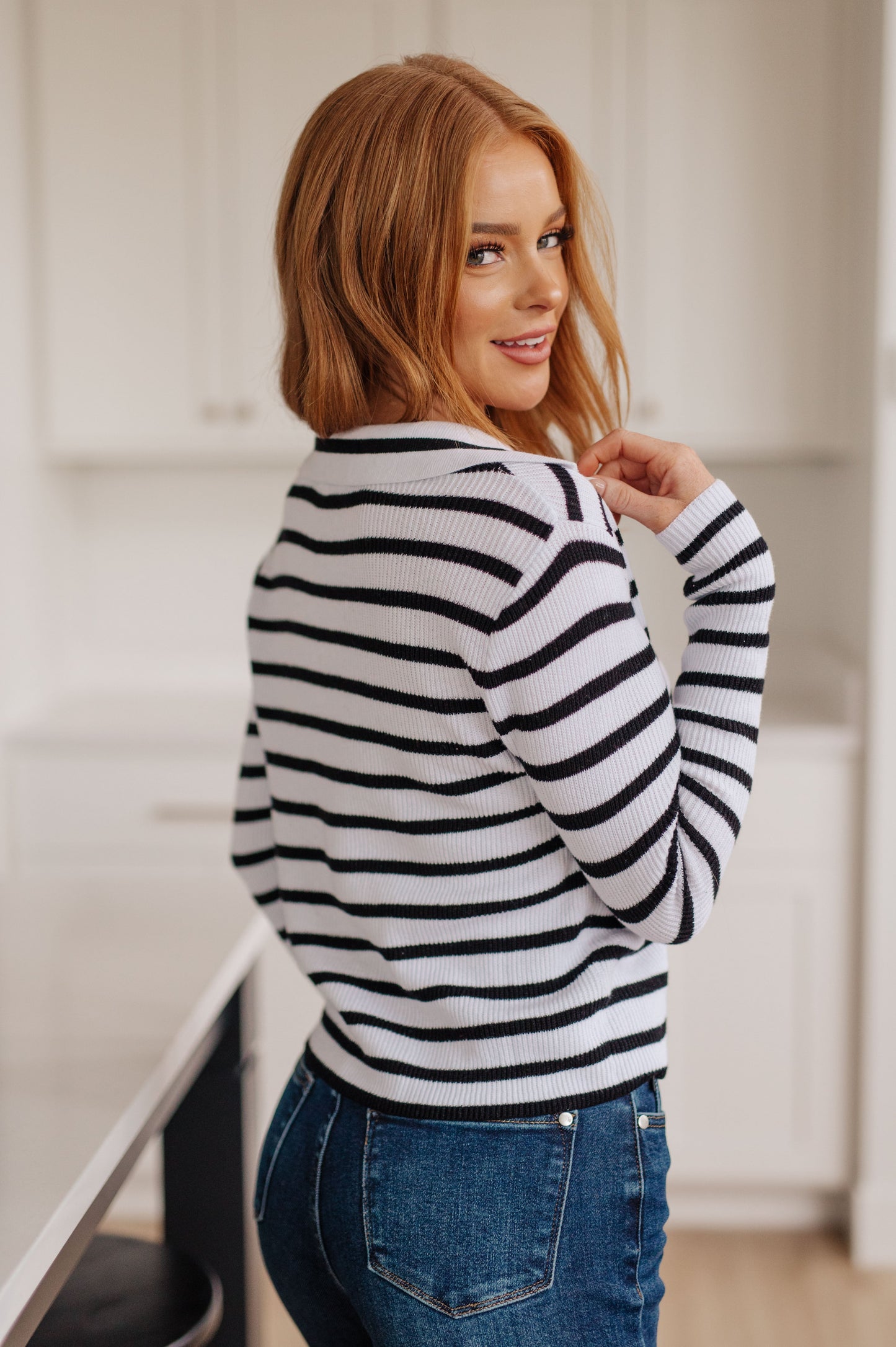 Back view of Bailey V-Neck Striped Sweater in black and white stripes, lightweight cotton knit, relaxed fit.
