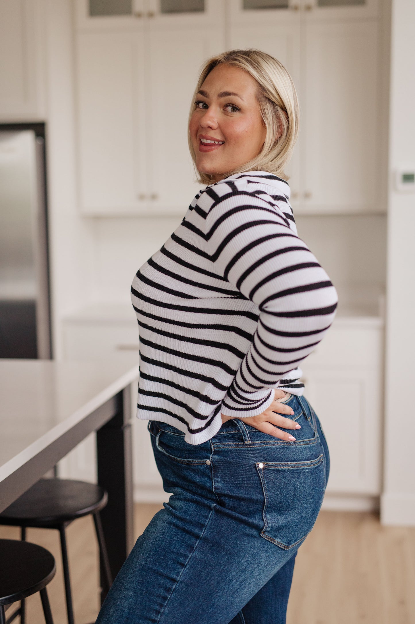 Side view of plus size Bailey V-Neck Striped Sweater, lightweight cotton knit, timeless black and white stripes.
