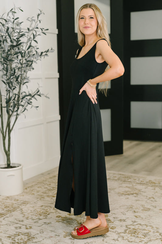 Black Betsy Maxi Dress, side angle showing scooped neckline and slit.