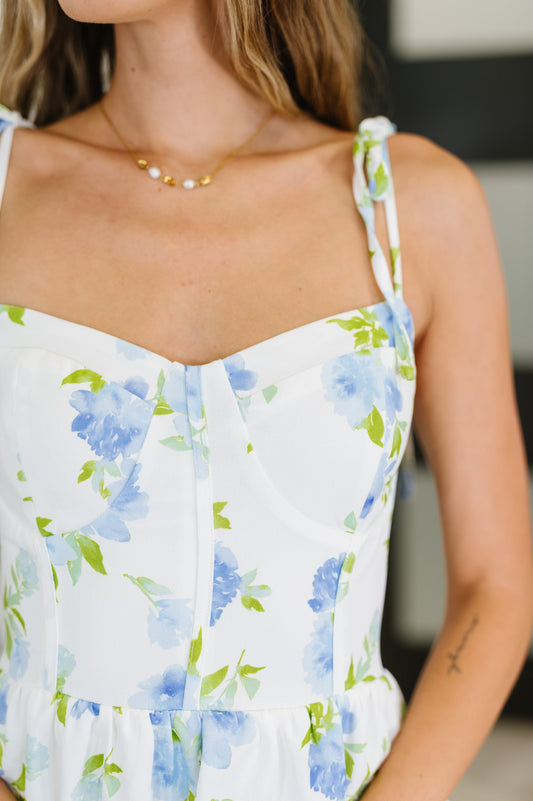 Close up view of the blue and ivory tiered maxi dress with sweetheart neckline and adjustable straps.