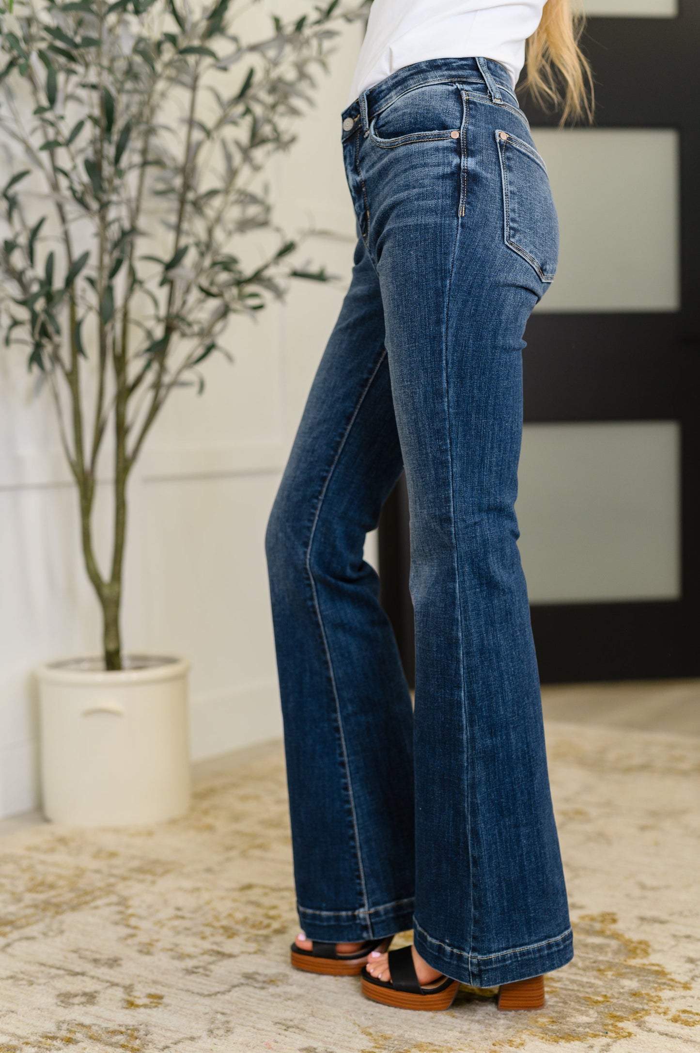 Side view of Bonnie High Waist Trouser Flare Jeans showing flattering fit, dark wash denim, and flared leg shape.