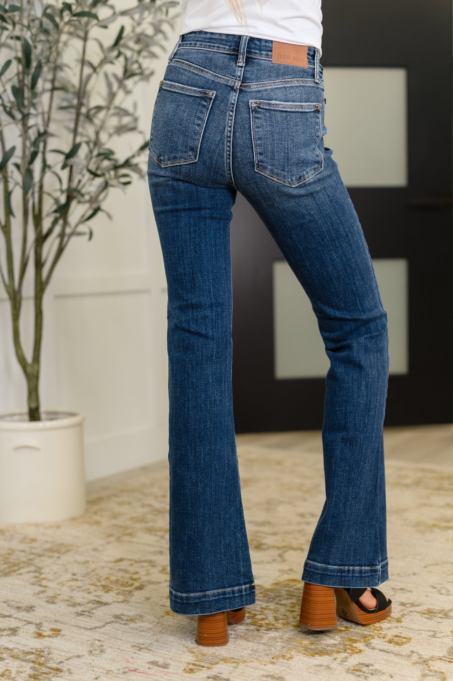 Back view of Bonnie High Waist Trouser Flare Jeans with high-rise waist and classic dark wash flare silhouette.