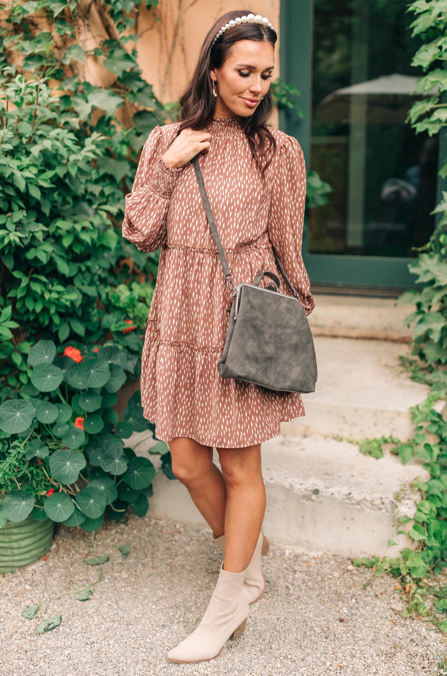 Woman wearing the Bridget Mini Charcoal Backpack crossbody style.