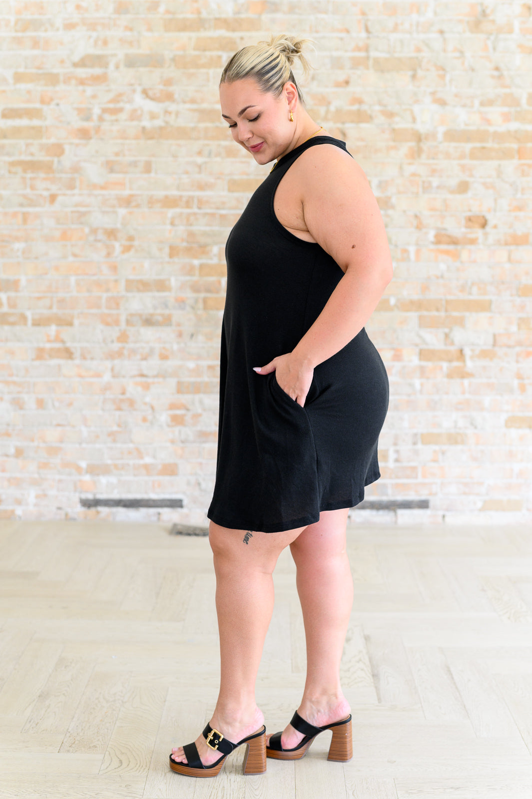 Side view plus size black Brynlee dress with bold crisscross back cut-out design.