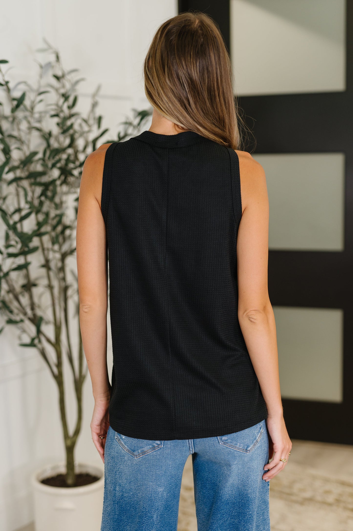 Back view of Alani Black Sleeveless Top in lightweight waffle knit fabric.