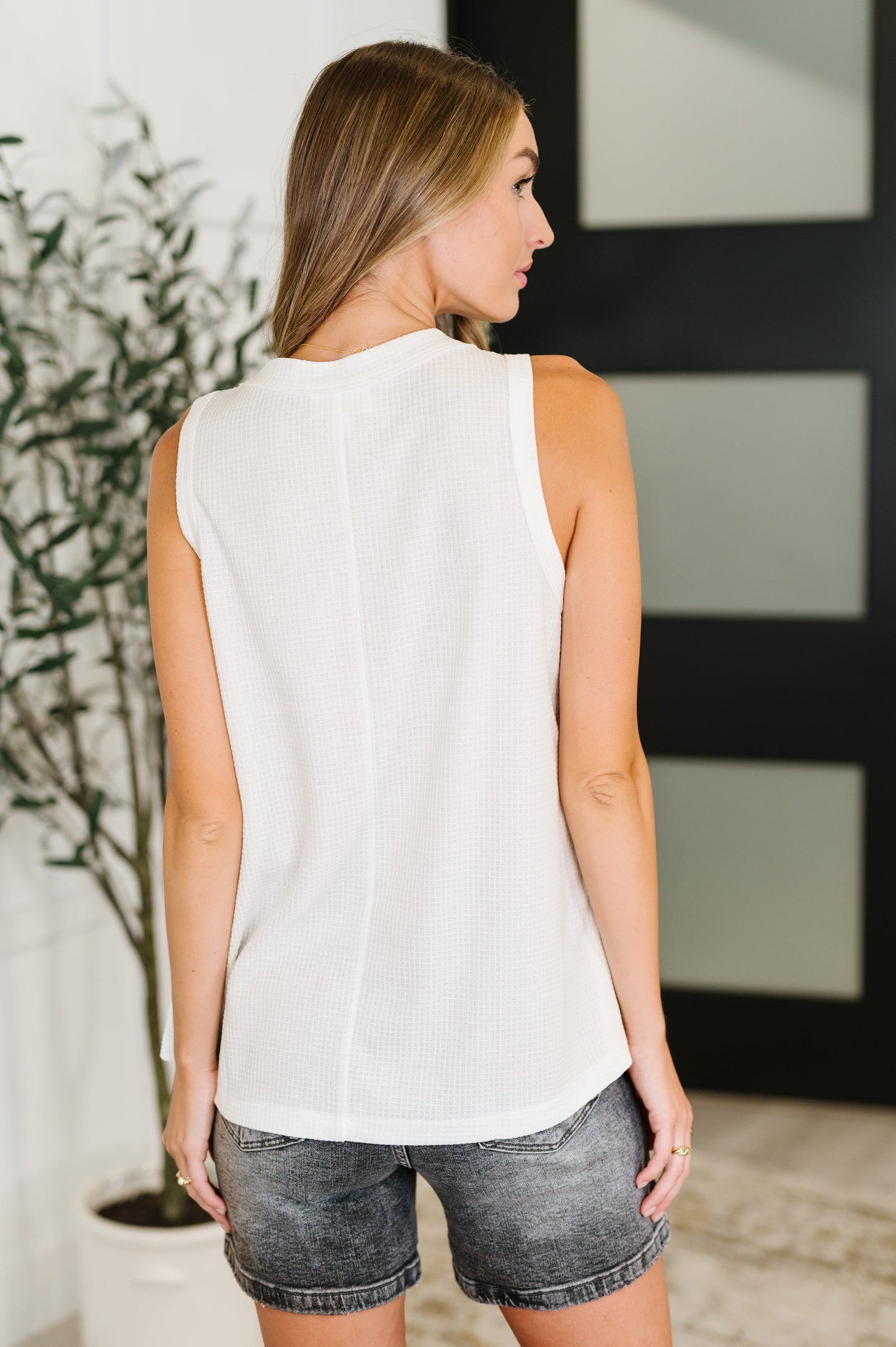 Back view of the Alani Sleeveless Top in ivory, showcasing the slightly sheer waffle knit fabric and relaxed fit.