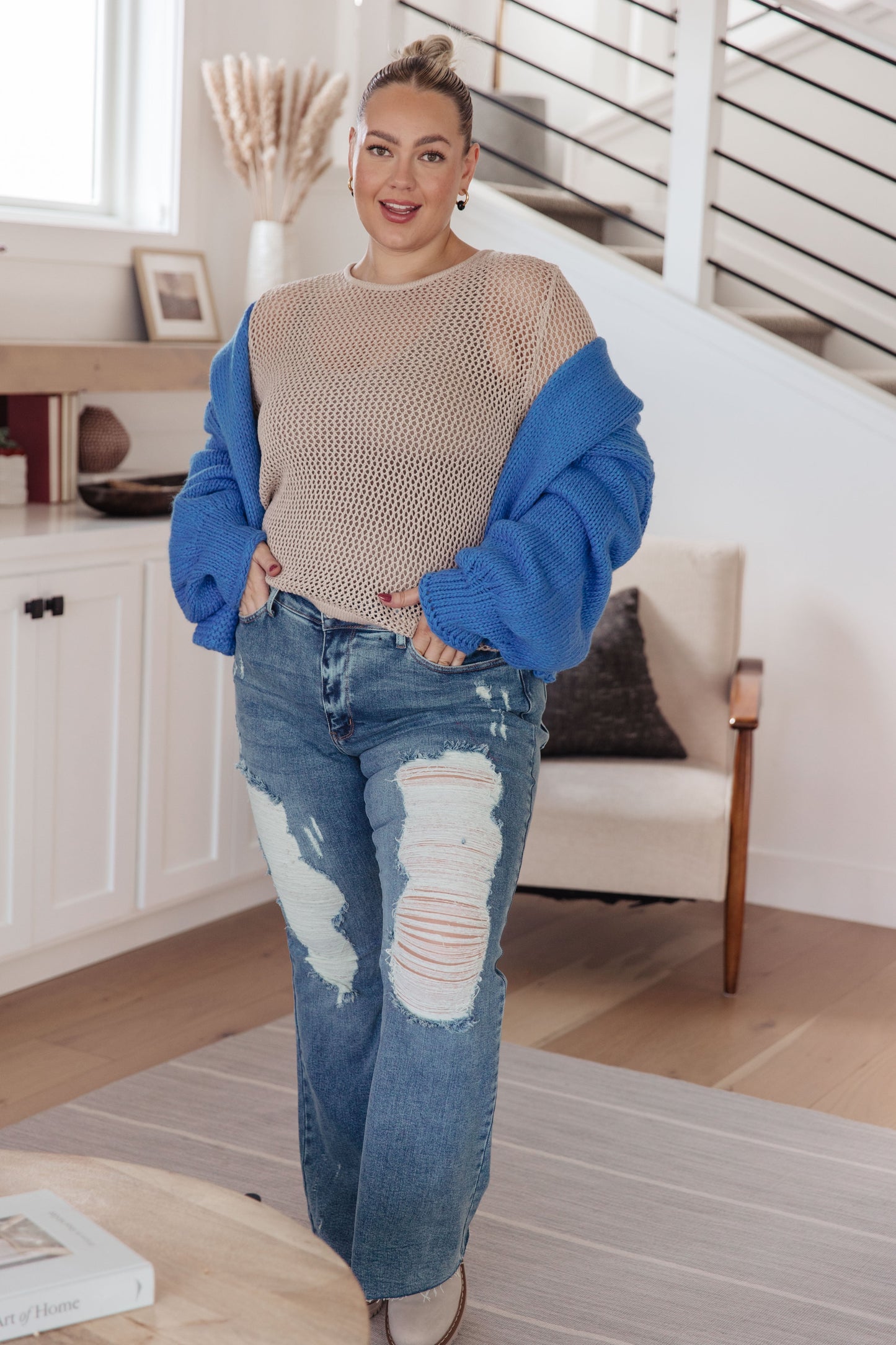 Plus size full body view showing Landis Loose Knit Top in cream, styled over a tank with long sleeves and open-knit design.