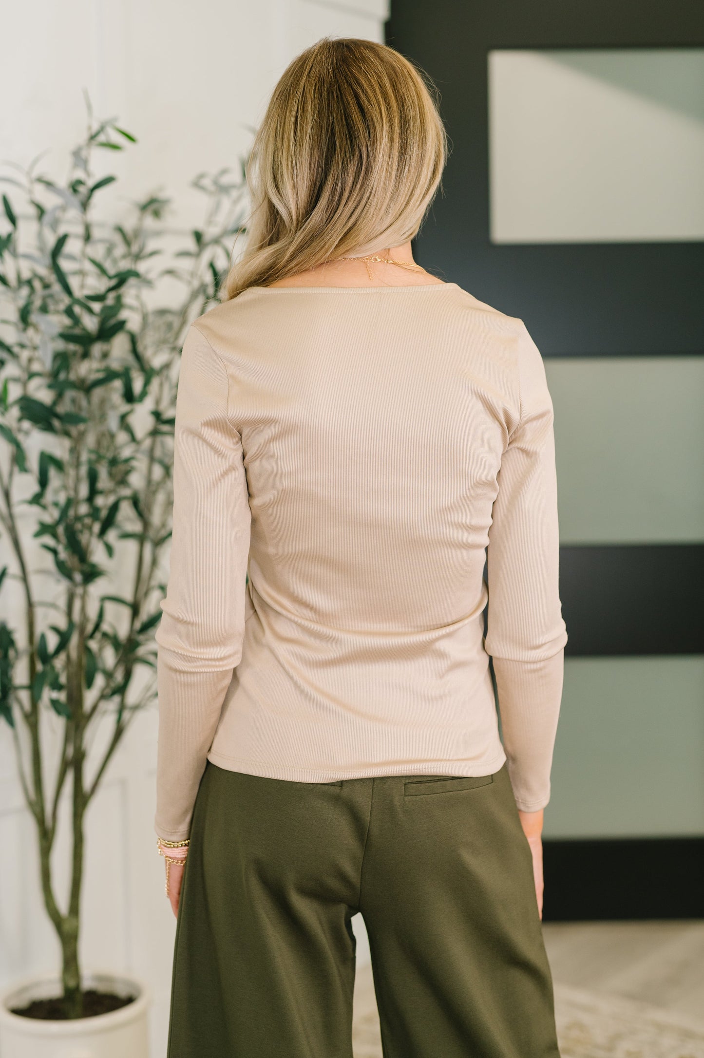 Back of Laura Basic Long Sleeve Top in Sand highlighting ribbed texture and long sleeves.