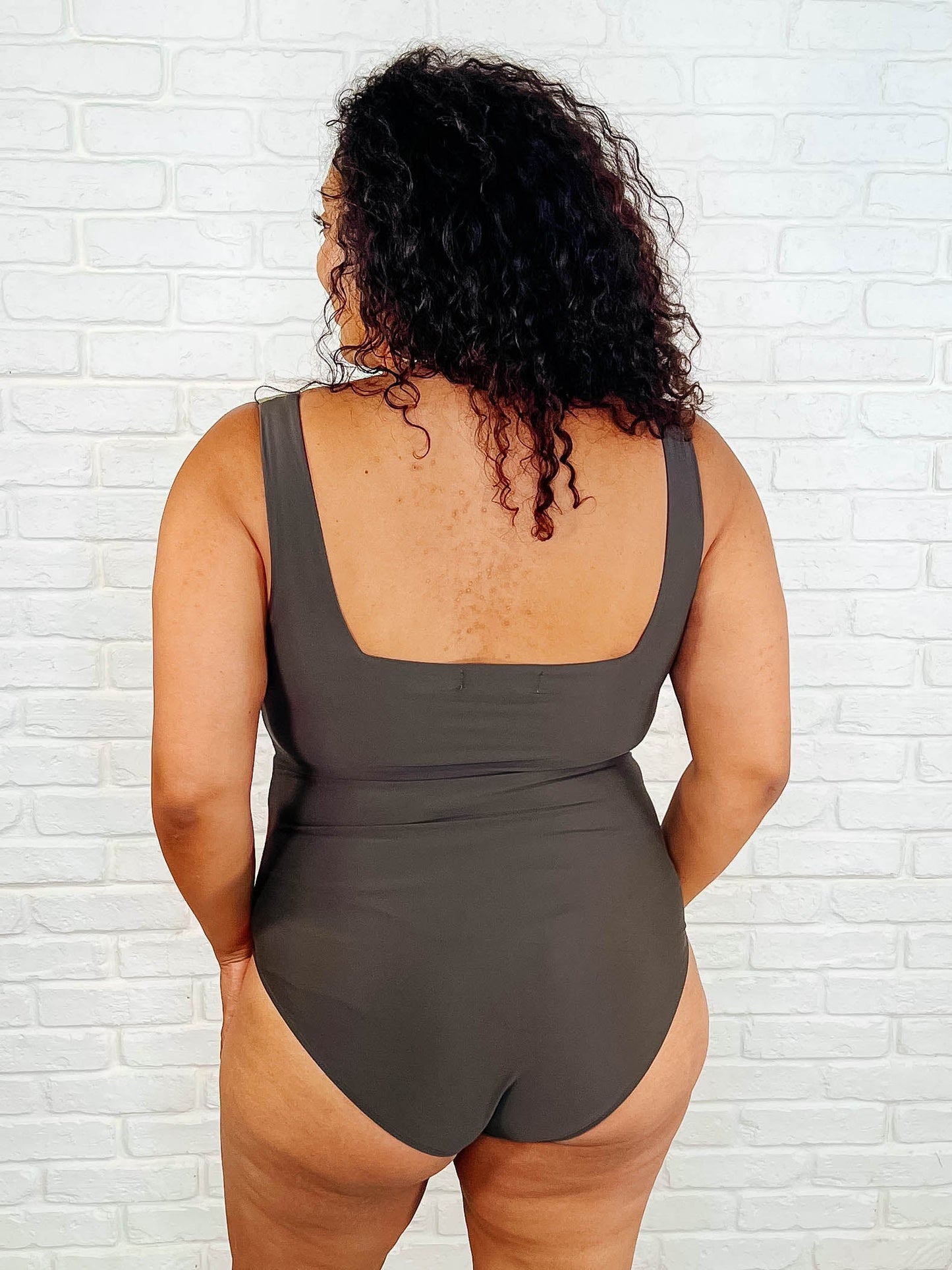 Back view of plus size Cape Town Asymmetrical Stripe Swimsuit cheeky fit silhouette.