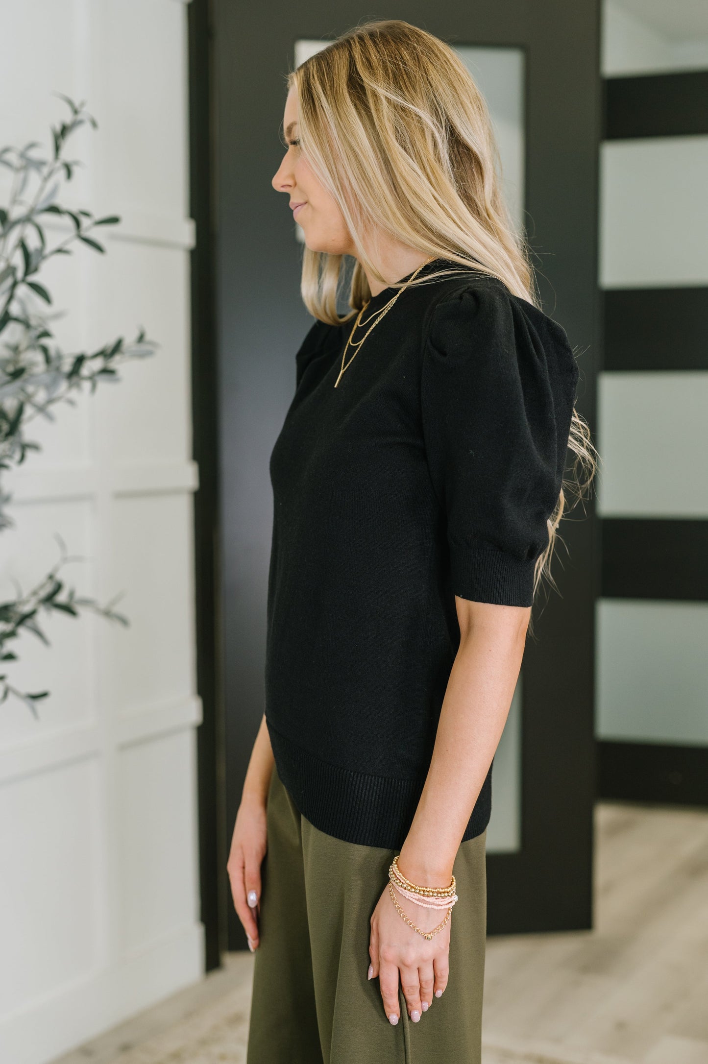 Giselle Puff Sleeve Blouse in Black, side view highlighting puff sleeve and slim fit.