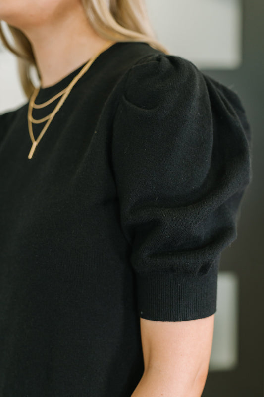Giselle Puff Sleeve Blouse in Black, close-up of ribbed knit puff sleeve and banded cuff detail.