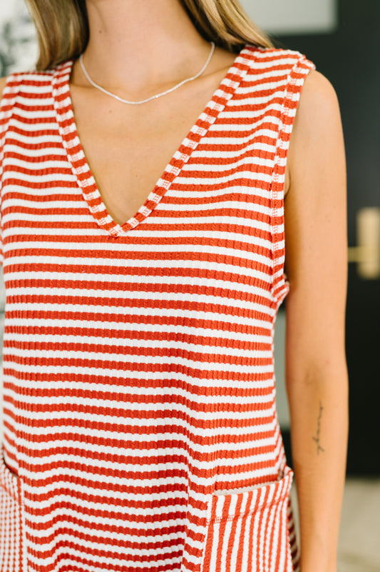 Close-up of Julia Ribbed Knit Romper showing ribbed cable knit fabric and banded neckline detail in rust.